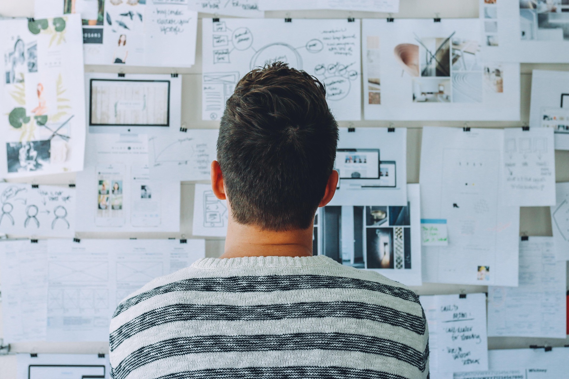 Person reviewing tax documents on a bulletin board – reflecting on Canada tax changes for 2025