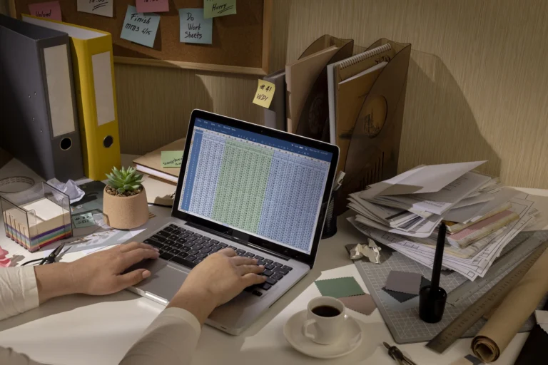 Messy table with invoices and financials reflecting the need for bookkeeping services