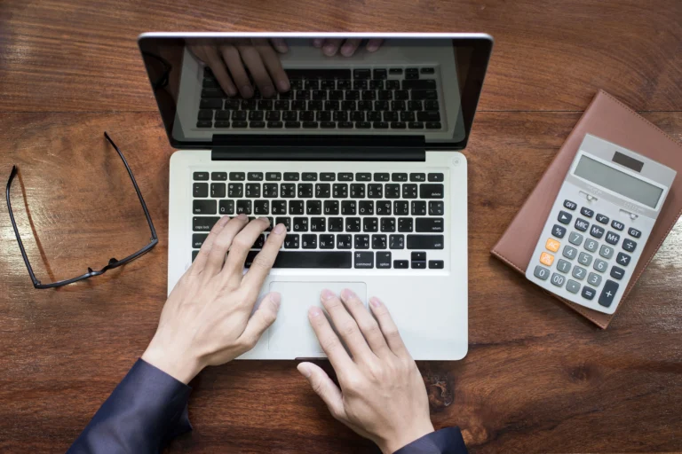 Canadian small business owner reviewing integrated bookkeeping software reports