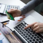 A person typing credit card details.