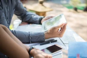People looking at small business grants documents.