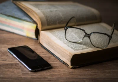 glasses-1052023-1-scaled-1-1-1-2-1-1-1-1-1-1-1-1-1 Books, glasses, and mobile phone setup for financial learning resources